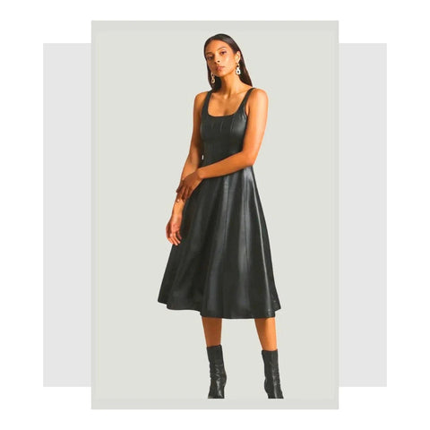 New arrivals at Queen Anna House of Fashion. A woman in a black faux leather skater dress.