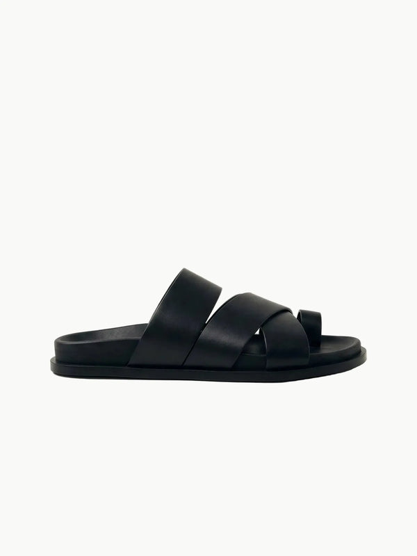Black sandal on a light beige background