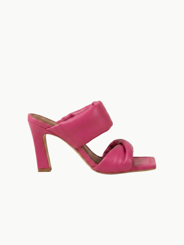 Pink high-heeled sandal on a light beige background