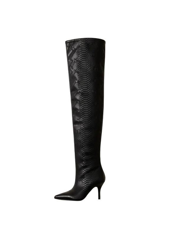 Black knee-high boot with snake pattern on a textured white and beige background