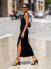 A woman in a black dress and sunglasses walks, showcasing Jaggar Woven Leather Wedge Sandals.