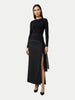 Woman wearing a black dress with a slit on a white background