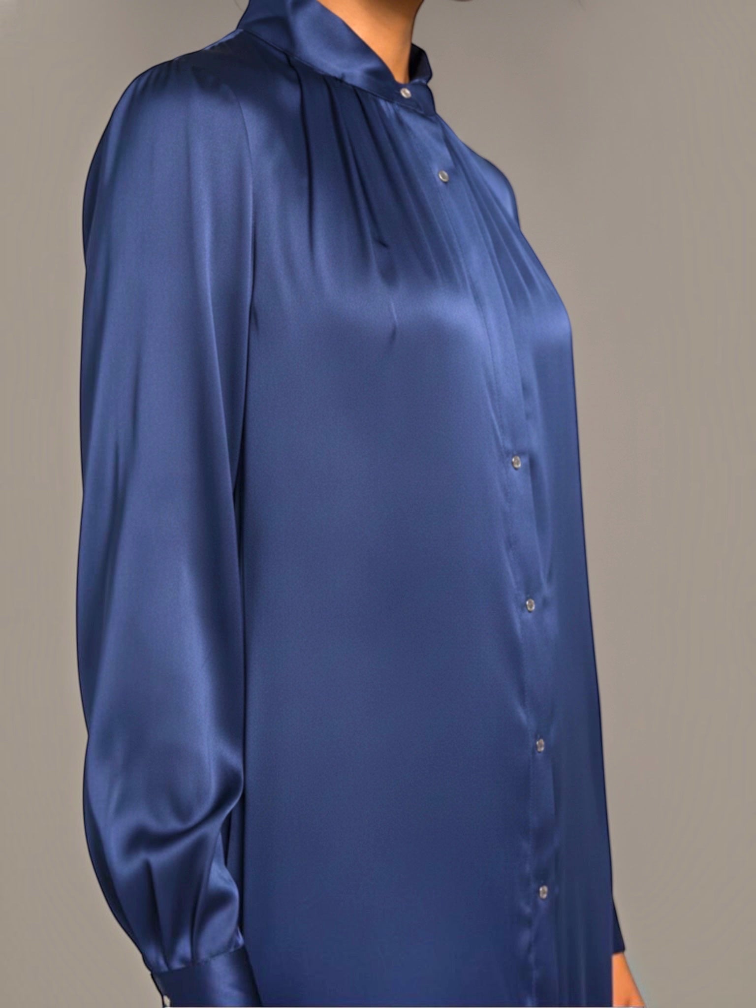 The Camilla Dress by Neu Nomads is constructed from 100% Satin TENCEL™ Modal, with a refined polo collar, long sleeves, and a button-up shirt dress silhouette featuring a 2-inch belt. Biodegradable mother-of-pearl shell buttons and French seam finishing complete the garment.