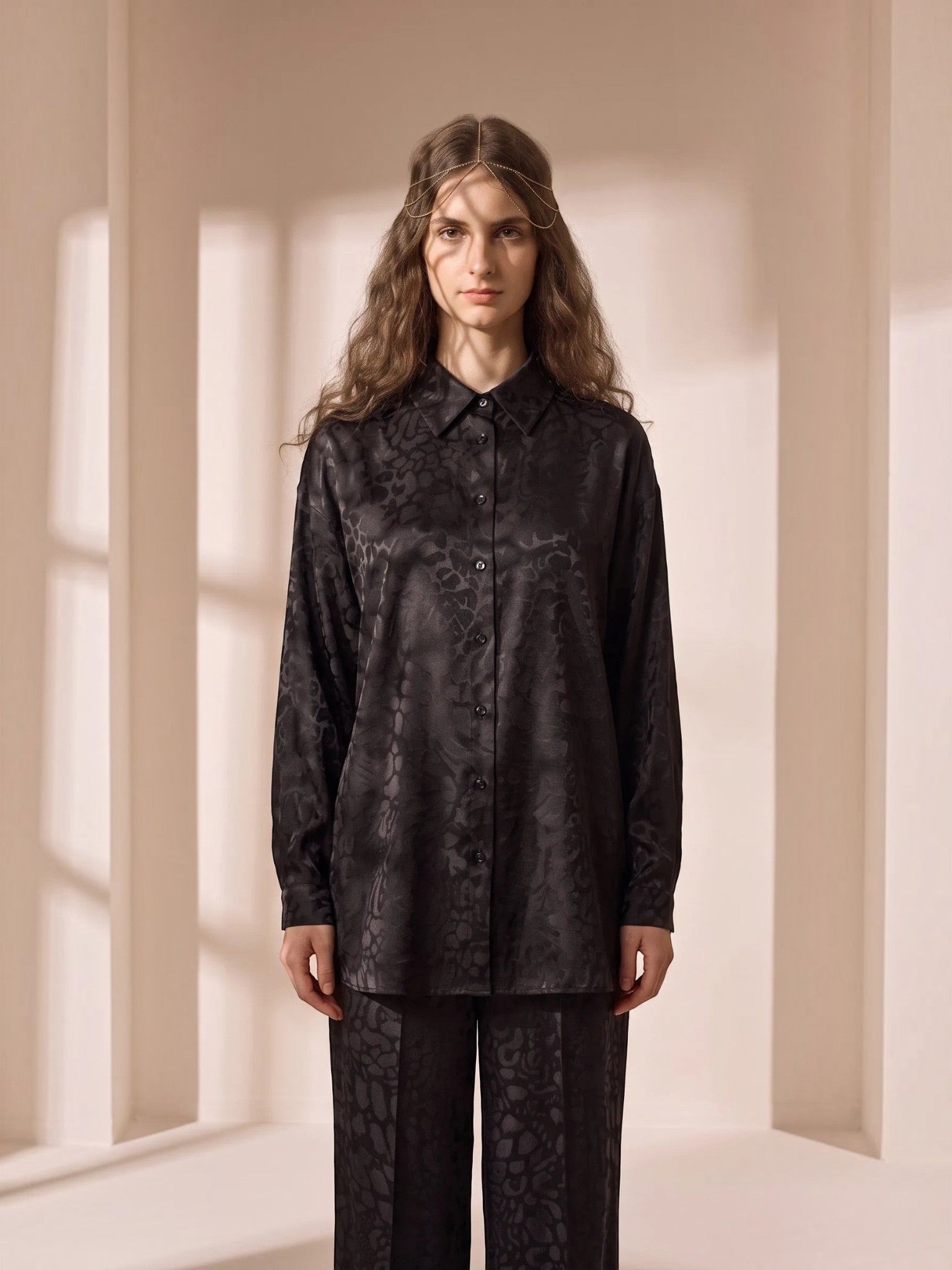 Model wearing a Queen Anna House of Fashion black satin button-down shirt with a subtle tonal animal print pattern.