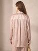 Back view of a model wearing a Queen Anna House of Fashion beige satin shirt with a subtle textured pattern.
