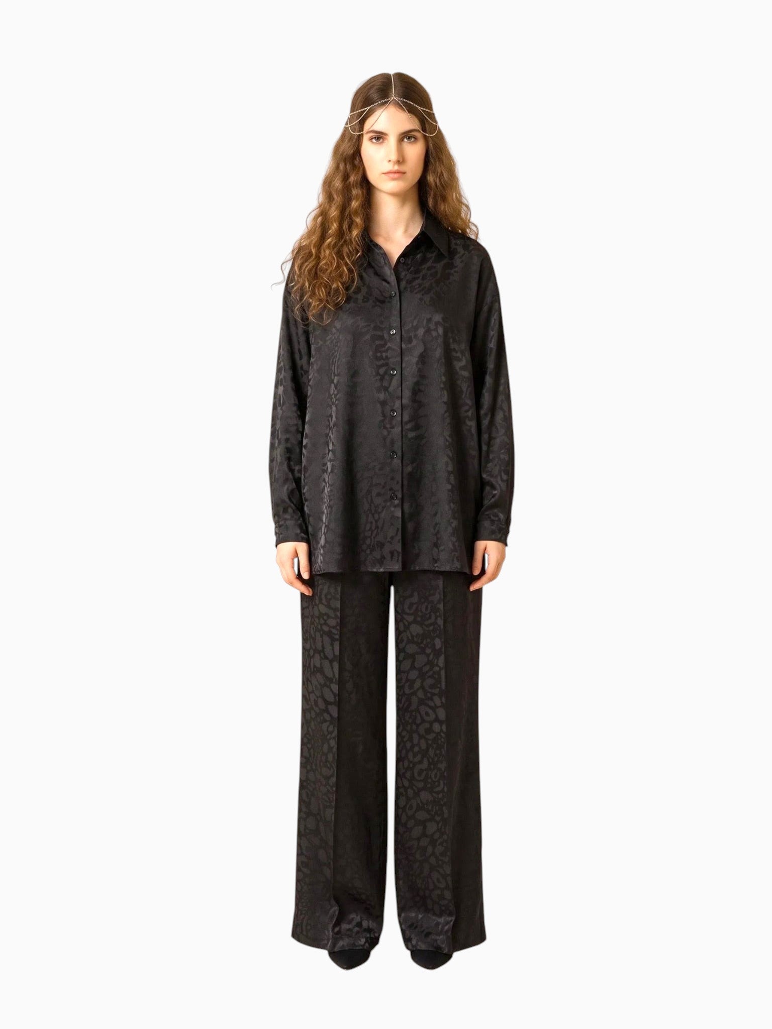 Model wearing Queen Anna House of Fashion black satin button-down shirt and matching wide-leg pants with subtle print.