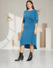 Model wearing a blue Queen Anna House of Fashion jersey cinched dress with a high-low hem and three-quarter sleeves.
