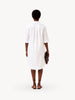 Person wearing a white dress on a white background