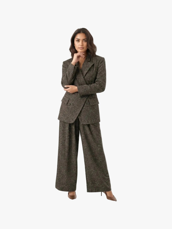 Woman wearing a brown checkered suit on a white background