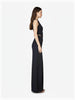 Side profile of model wearing Article X Black Wide Leg Pant and sleeveless crop top, showing structured design
