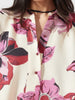 Close-up detail of Lanhtropy Sake Linen Tencel Dress neckline, buttons, and floral linen fabric texture