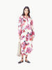 Model wearing Lanhtropy Sake Linen Tencel Dress in floral hibiscus print, front product shot on ivory background