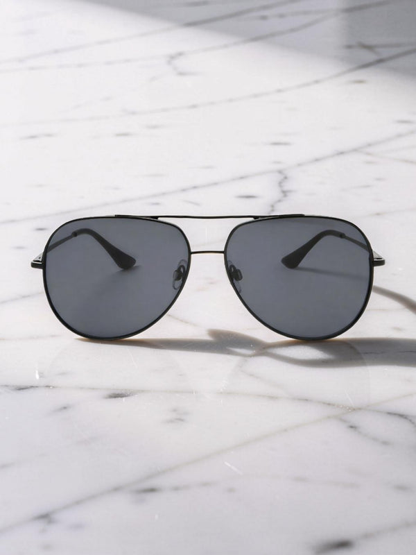 Aviator sunglasses with dark lenses on a marble surface