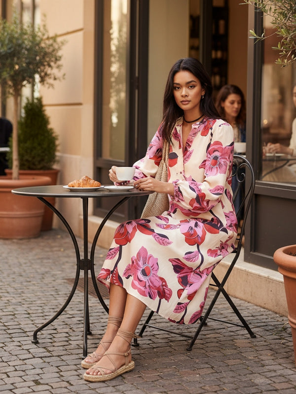 Model wearing Lanhtropy Sake Linen Tencel Dress sitting at an outdoor cafe table, lifestyle view