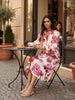 Model wearing Lanhtropy Sake Linen Tencel Dress sitting at an outdoor cafe table, lifestyle view