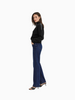 Queen Anna House of Fashion black knit sweater with white contrast stitching on shoulders worn with dark blue jeans