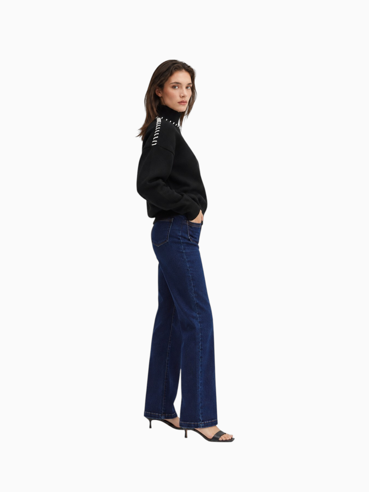 Model wearing Queen Anna House of Fashion black knit sweater with white contrast stitching and dark blue denim jeans