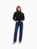 Queen Anna House of Fashion black knit sweater with white contrast stitching on the shoulders and neck, worn with jeans