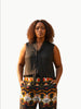 Queen Anna House of Fashion model wearing a black sleeveless Universal Standard Brava cupro blouse with a tie neck.