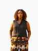 Queen Anna House of Fashion model wearing a black sleeveless Universal Standard Brava cupro blouse with a tie neck