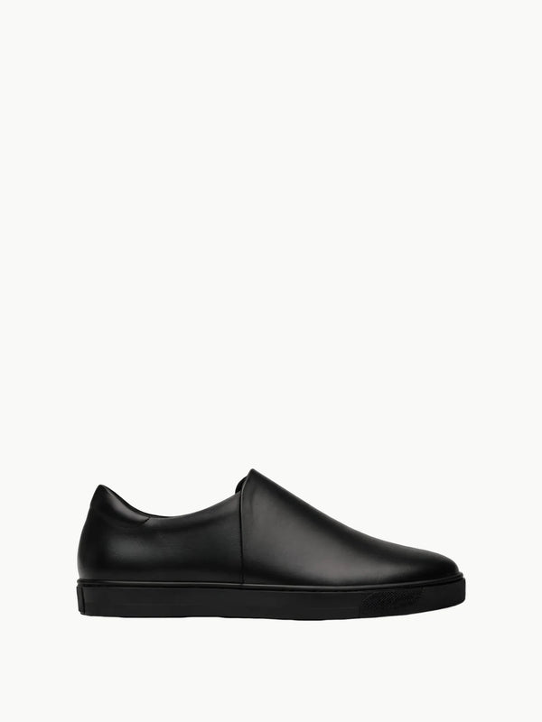 Queen Anna House of Fashion black leather minimalist slip-on sneakers with a sleek, modern design and durable rubber sole.