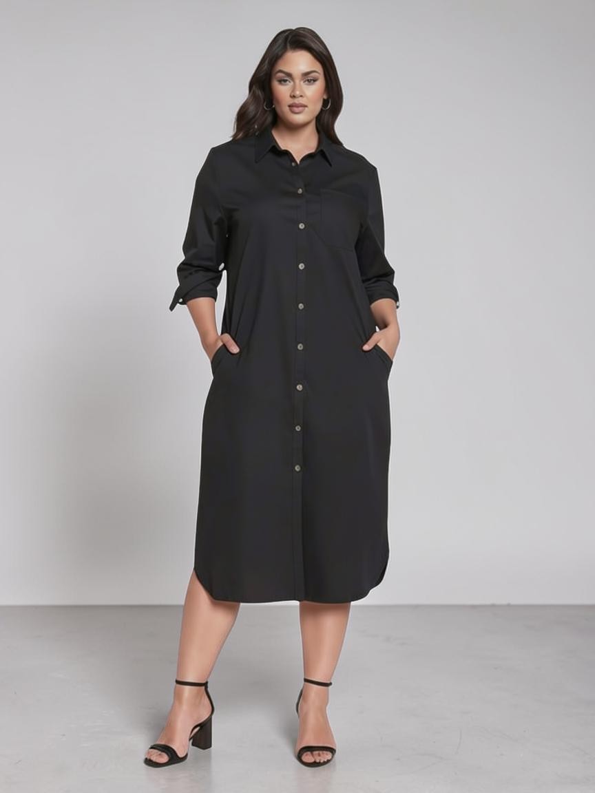 Queen Anna House of Fashion model wearing a black Universal Standard stretch poplin shirtdress with pockets