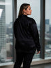 Queen Anna House of Fashion model wearing a black Universal Standard satin bomber jacket with a relaxed fit
