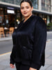 Queen Anna House of Fashion model wearing a black Universal Standard satin bomber jacket with zip pockets