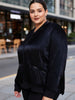 Queen Anna House of Fashion model wearing a black satin bomber jacket with zip pockets and tonal rib trim