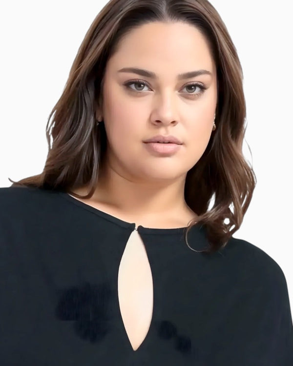 Queen Anna House of Fashion model wearing a black Universal Standard Divine Jersey shift dress with a keyhole neck.