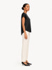 Model wearing Queen Anna House of Fashion black washable silk charmeuse blouse with a relaxed fit and side view