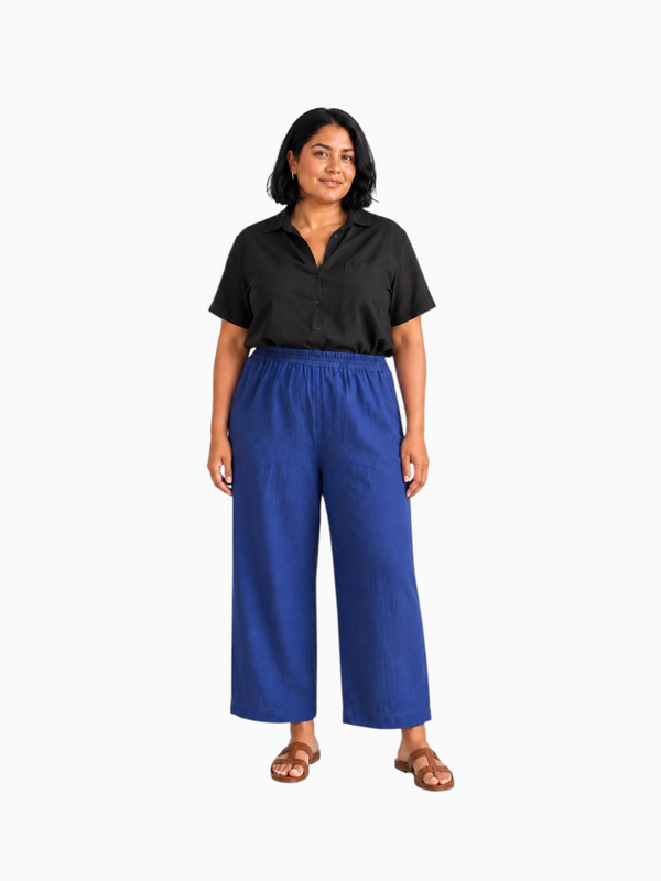 Model wearing Queen Anna House of Fashion Universal Standard blue linen-blend straight-leg pants with elastic waist