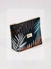 Queen Anna House of Fashion Bossy Cosmetics nylon makeup bag with black tropical leaf print and gold zipper detail.
