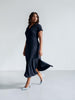 Queen Anna House of Fashion model wearing a navy blue Universal Standard Divine Jersey shift dress with side slits.