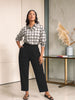 Queen Anna House of Fashion model wearing a white and black plaid stretch poplin button-down shirt with black trousers.