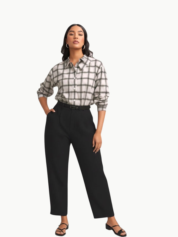 Queen Anna House of Fashion model wearing a white and black plaid stretch poplin button-down shirt with black trousers.