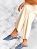 Model wearing Queen Anna House of Fashion Rebecca Allen slate blue leather flat mules with a notched backline.