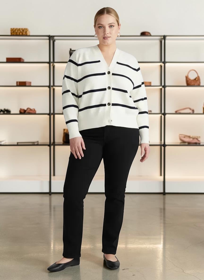 Queen Anna House of Fashion model wearing a white and black striped Better Than Wool cardigan with black trousers.