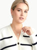Queen Anna House of Fashion model wearing a white and black striped Better Than Wool cardigan with a V-neckline.