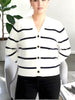 Model wearing a Queen Anna House of Fashion white and navy striped Better Than Wool V-neck button-up cardigan.