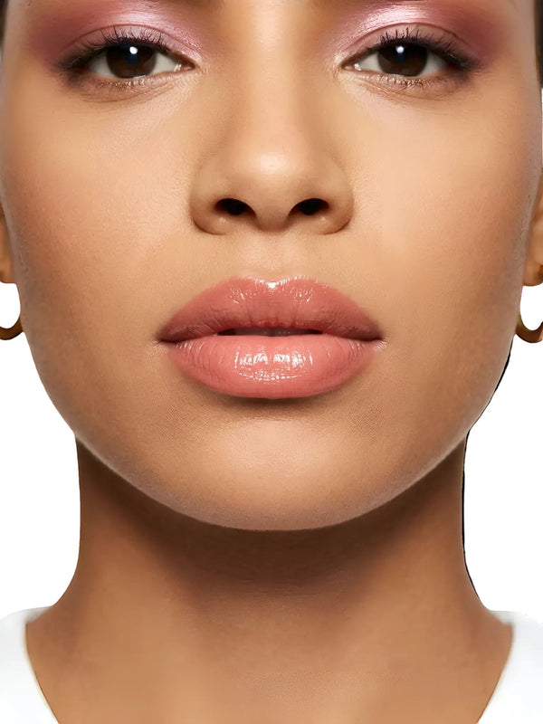 Model wearing Queen Anna House of Fashion Bossy Cosmetics Unapologetic pink nude lip gloss with a high-gloss finish.