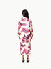 Rear view of model wearing Lanhtropy Sake Linen Tencel Dress in floral print showing back view