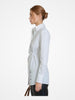 Side profile of model wearing Article X White The Wrap Button Down Shirt showing tailored silhouette