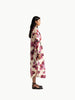 Side profile of model wearing Lanhtropy Sake Linen Tencel Dress in floral print showing side view